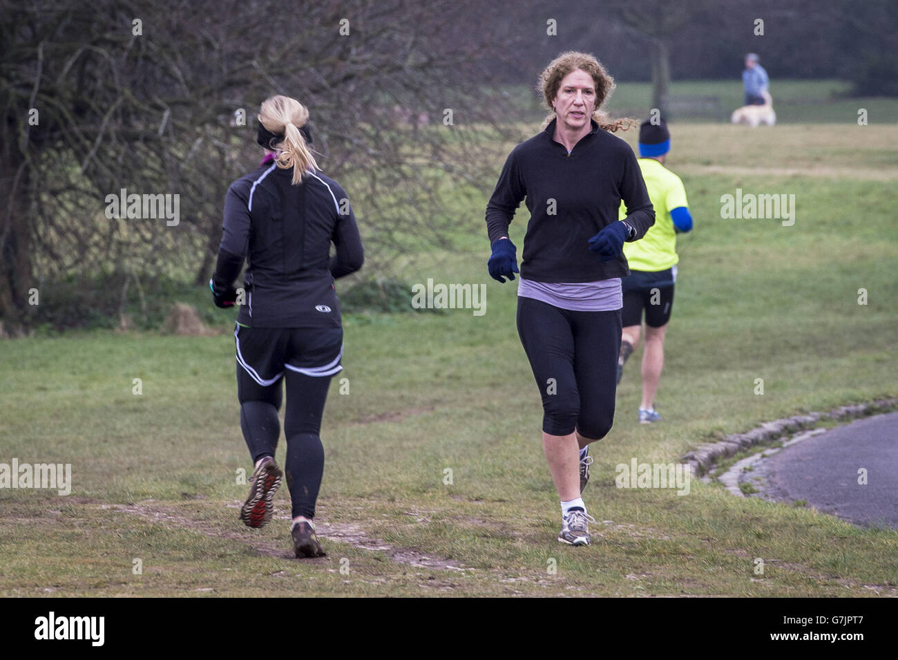 Joggers run around Clifton Downs, Bristol in the New Year, a traditional time of year for exercise. Stock Photo
