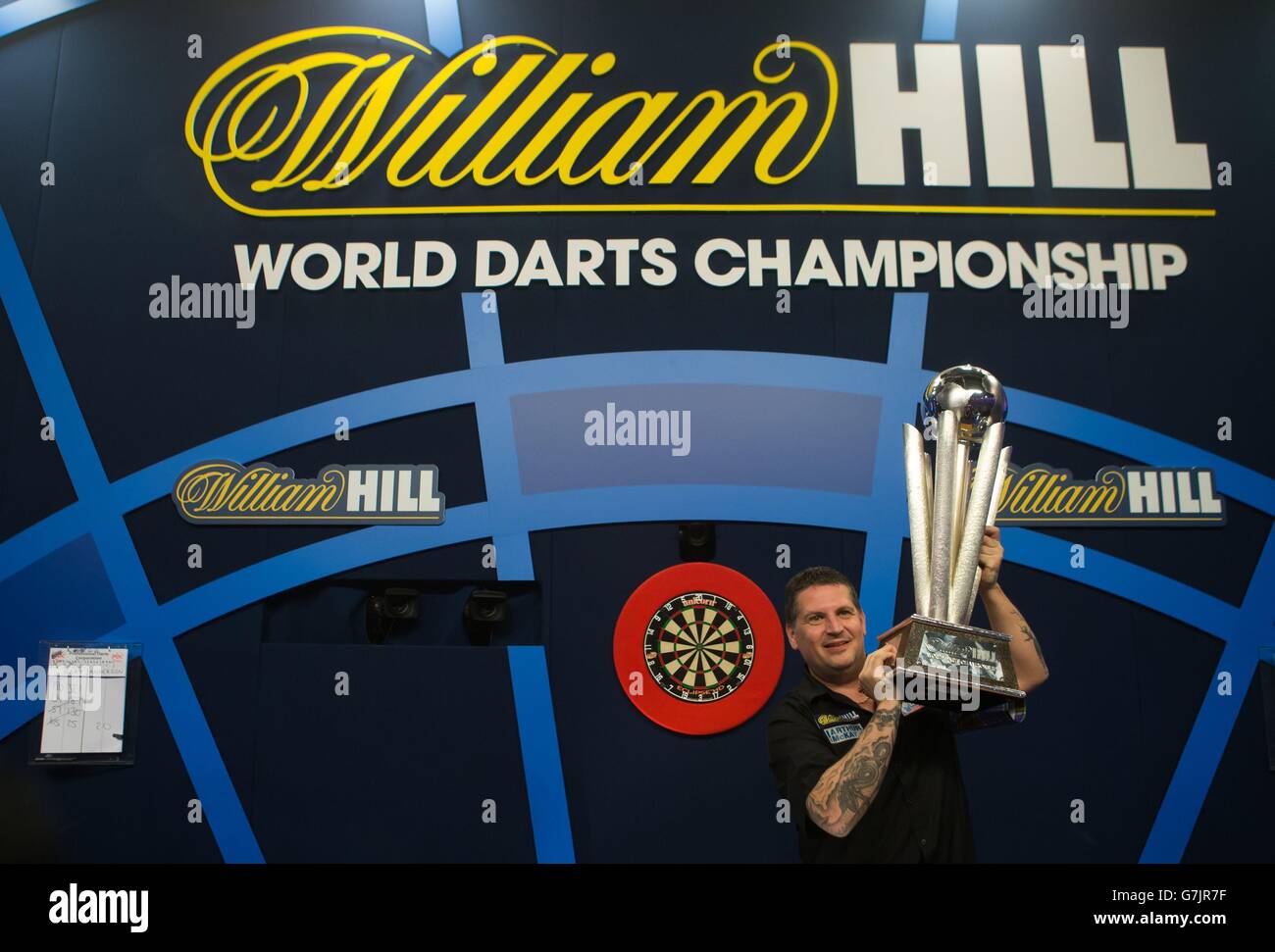 Gary Anderson celebrates with the Sid Waddell trophy after defeating