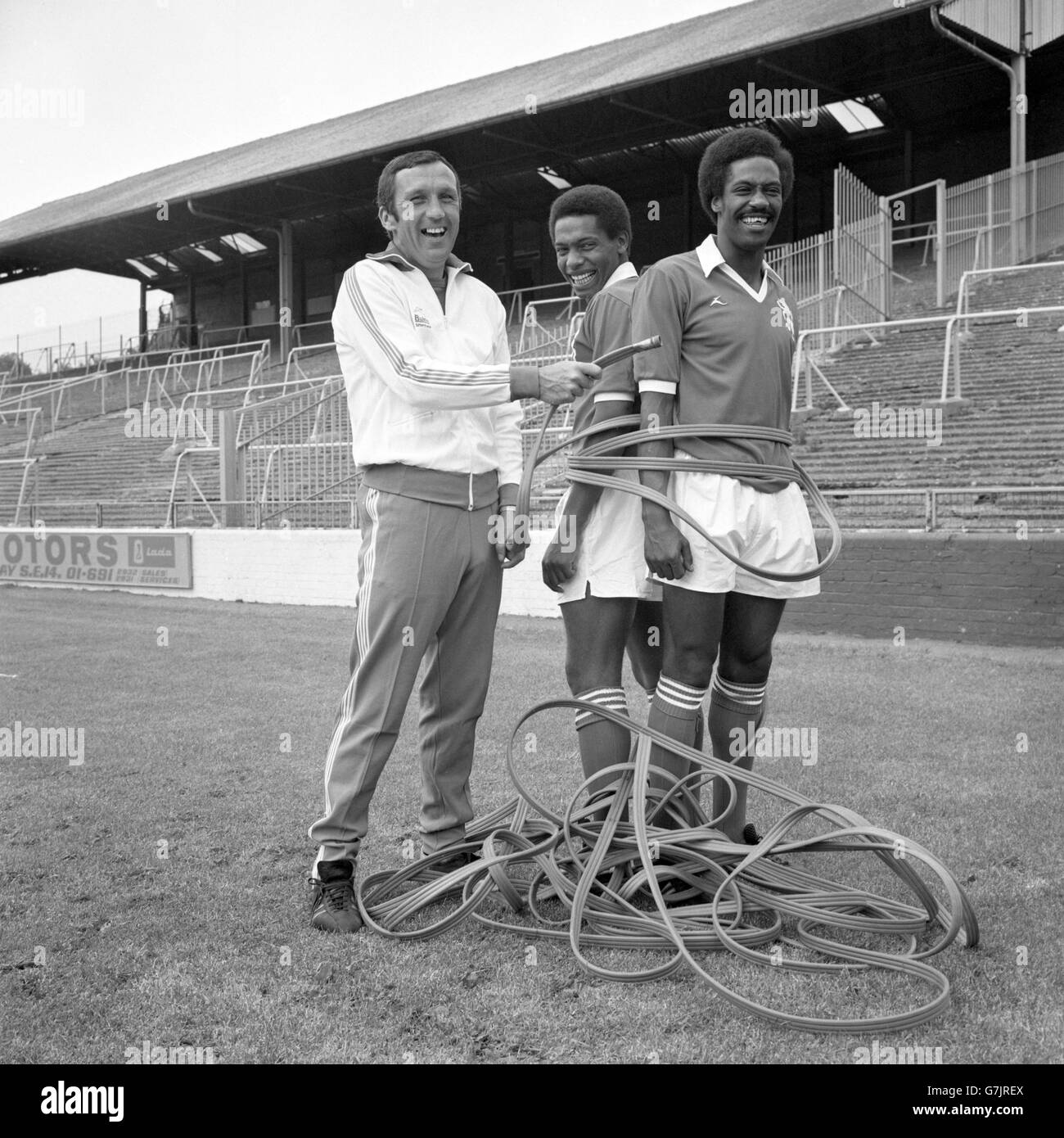 Millwall assistant manager Theo Foley wraps players Phil Walker and Trevor Lee up with a hose pipe in reference to the current drought. Stock Photo
