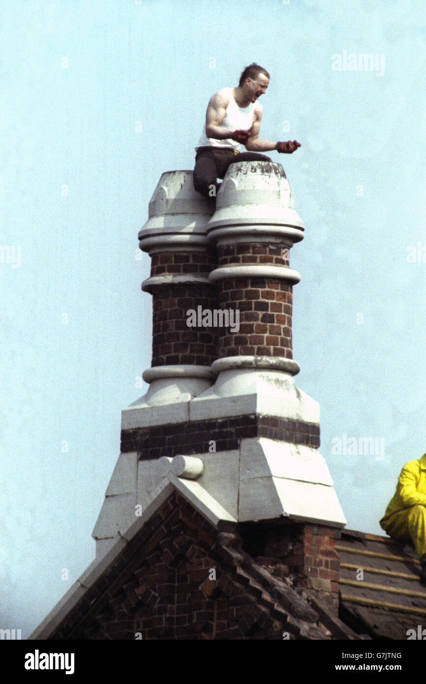 British Crime - Prison - Riots - Strangeways - Manchester - 1990. A prisoner shouts his protests from the roof of the Strangeways prison, where the siege finally ended today. Stock Photo