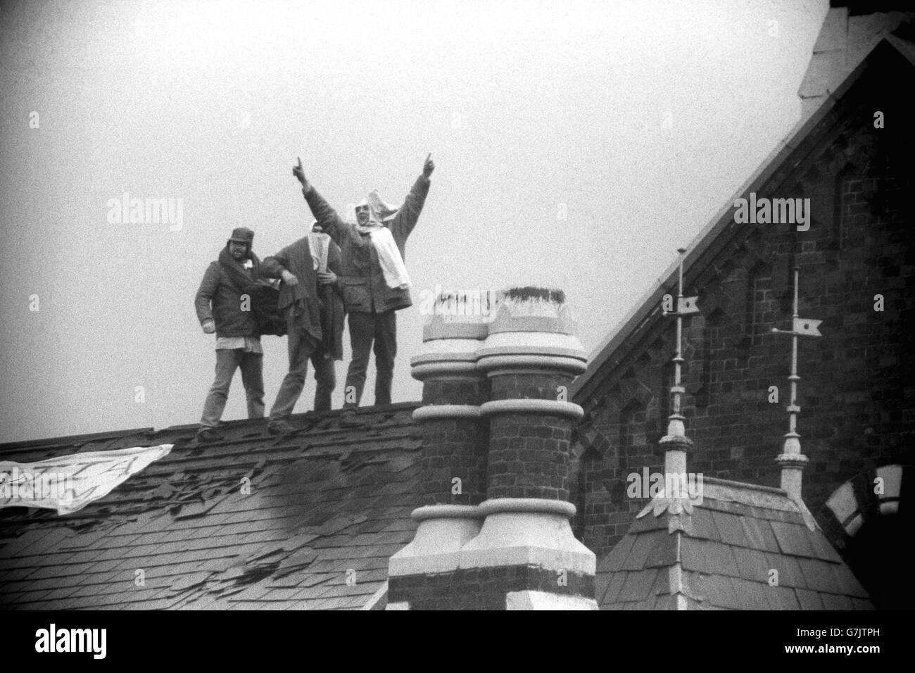 Defiant inmate on the roof of Strangeways prison in Manchester. Stock Photo