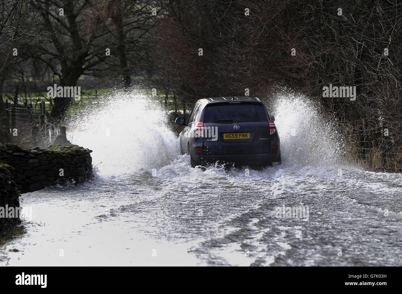 A car driving through flood water, as rapid snow melt overnight across the Yorkshire Dales