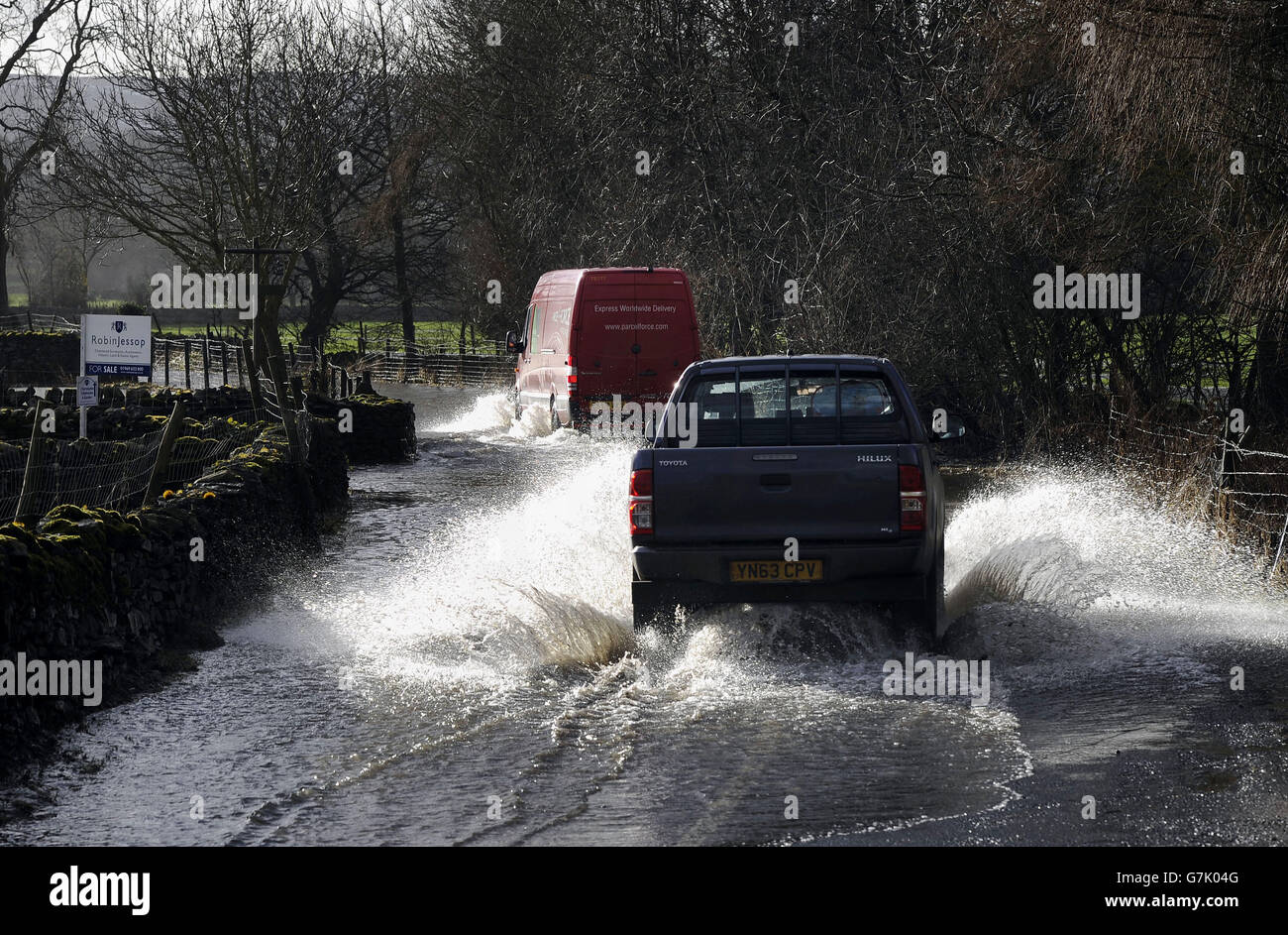 Vehicles driving through flood water, as rapid snow melt overnight across the Yorkshire Dales