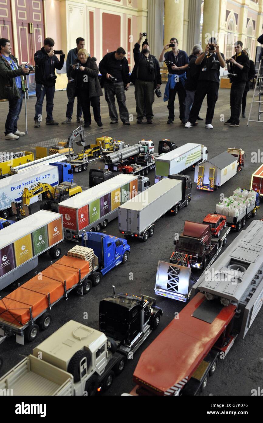 Modellers take photos of their remote control trucks during the preview