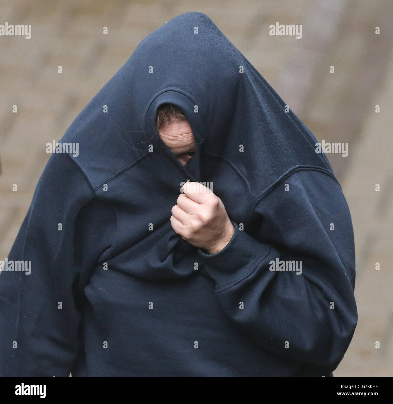 EDS NOTE POLICE OFFICERS FACE AND BADGE NUMBER PIXELATED BY PA PICTURE DESK Lisa Thompson leaves Ballymena Magistrates' Court where she was charged with handling stolen goods following the murder of Chinese restaurant owner Wing Fu 'Nelson' Cheung who was killed last week after robbers forced his car off the road in a remote area of Co Antrim. Stock Photo