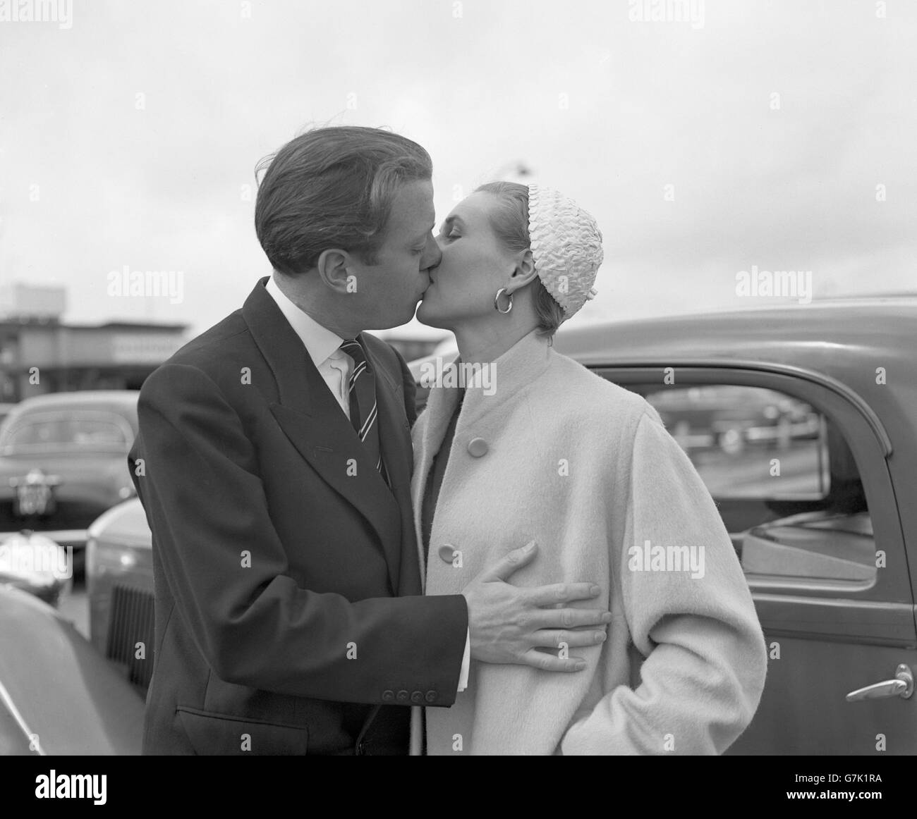 Sheila Sim gets a fond farewell kiss from her husband Richard Attenborough  as she left London Airport by BOAC plane for Nairobi. She is en route to  Mombasa and Zanzibar, where she