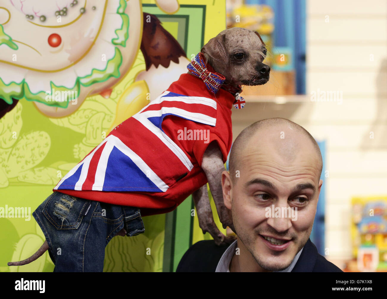Mark Hunt, Marketing Manager at Character Options, with Mugly, the World's Official Ugliest Dog, launching the Uggly's Pet Shop, which is a new range of collectable miniature Uggly Mutts - during the press preview for Toy Fair 2015, at Olympia in London. Stock Photo