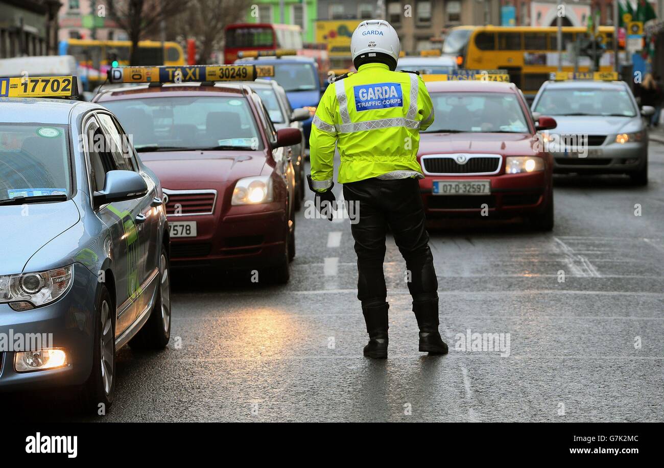 A member of Garda controls the traffic in Dublin, during a ...