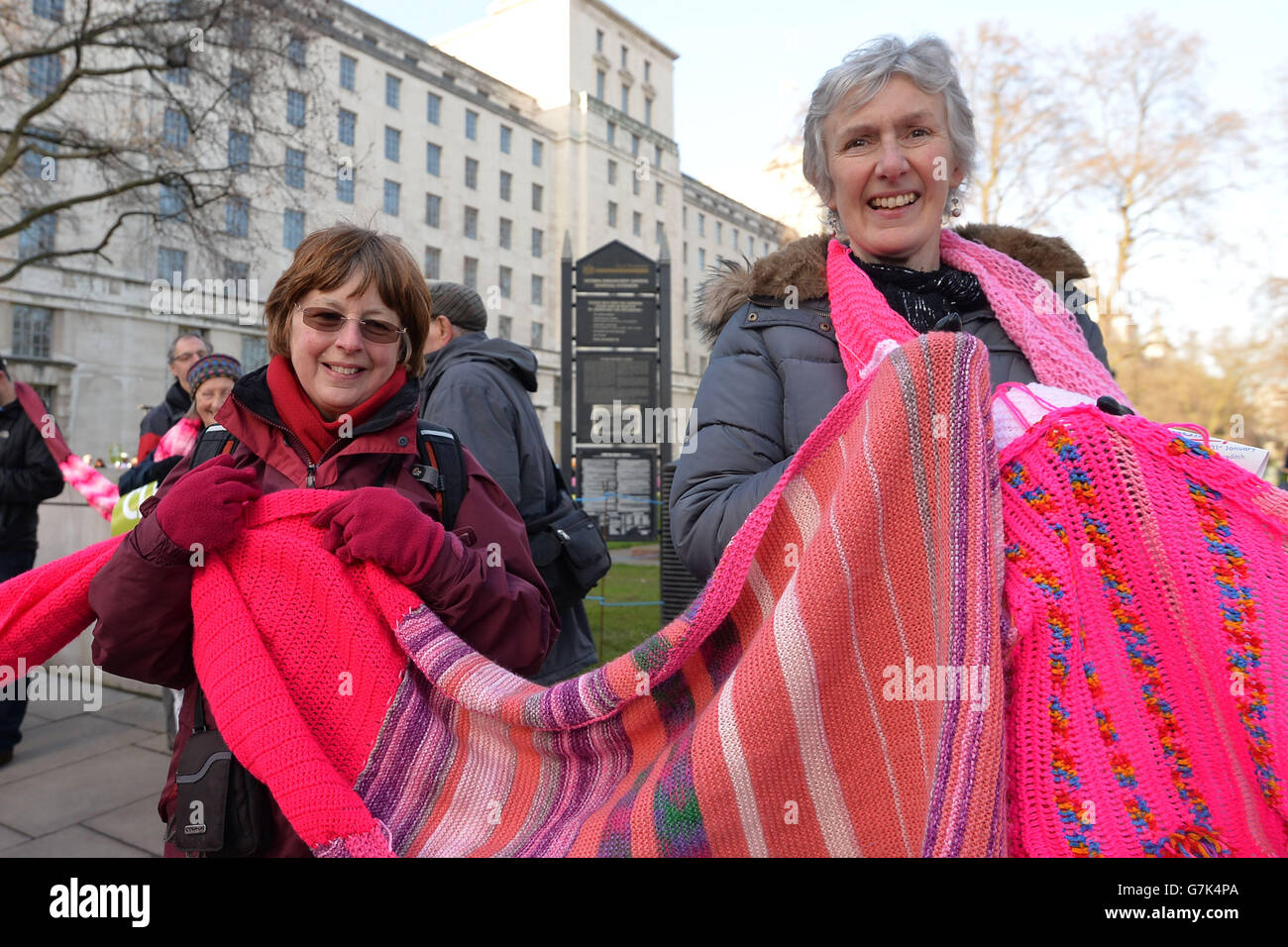Protesters hold a scarf during a CND march against Trident nuclear missiles in London. PRESS ASSOCIATION Photo. Picture date: Saturday January 24, 2015. The pink-coloured scarf, knitted by people across the world, will encircle the Ministry of Defence building in central London as part of the demonstration. See PA story POLITICS CND. Photo credit should read: John Stillwell/PA Wire Stock Photo