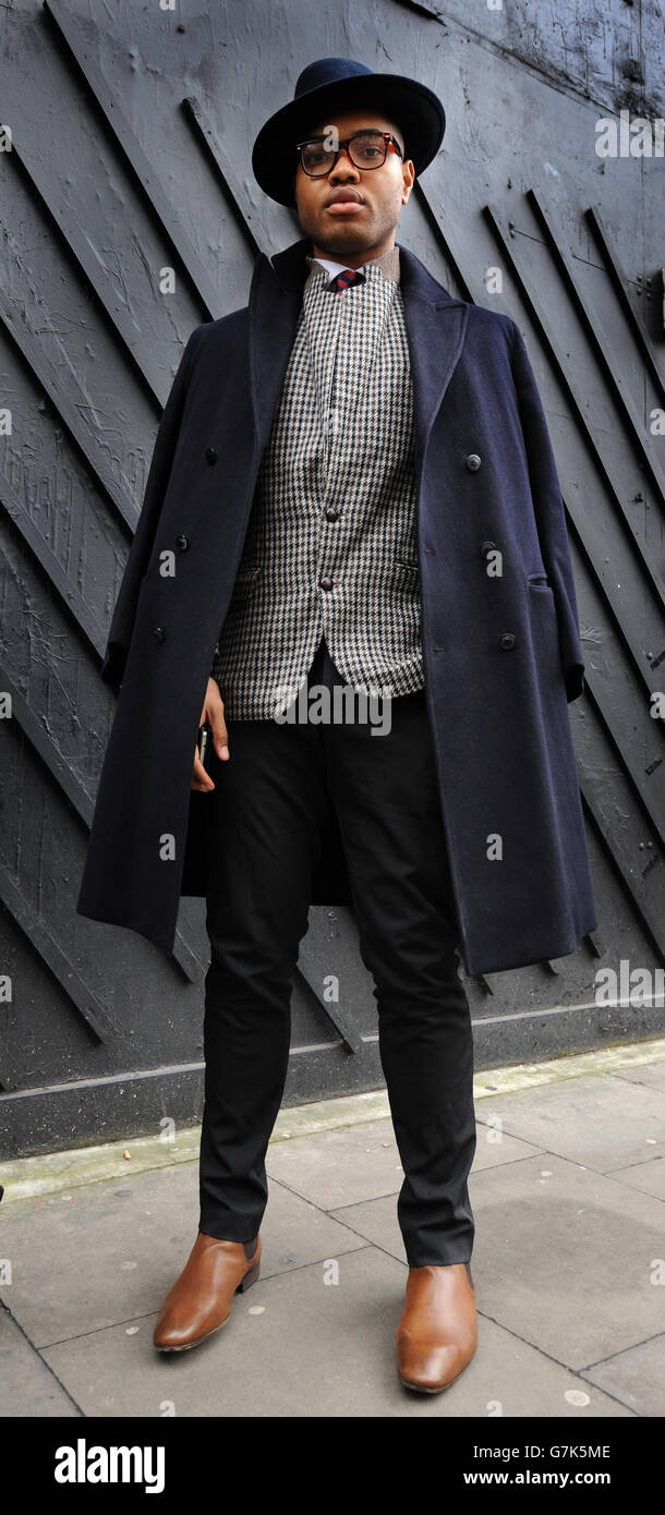 Omiri Thomas wears a vintage jacket and hat along with a blazer, trousers  and shoes from Zara outside the Old Sorting Office, London as he attended  the London Collections: Men event Stock