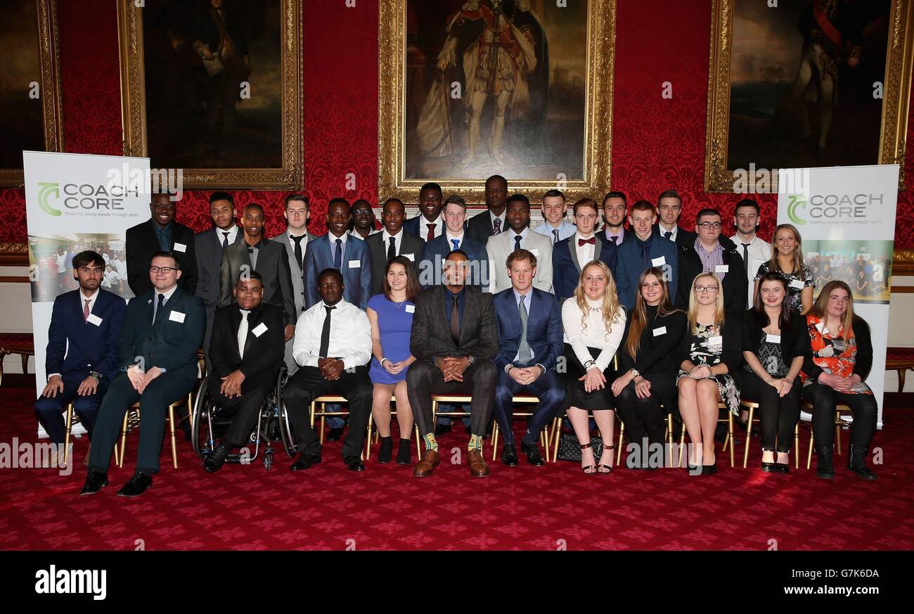 Prince Harry and NBA All-Star Carmelo Anthony pose for a photograph with Coach Core graduates during a Coach-Core Graduation event at St James's Palace in London. Stock Photo