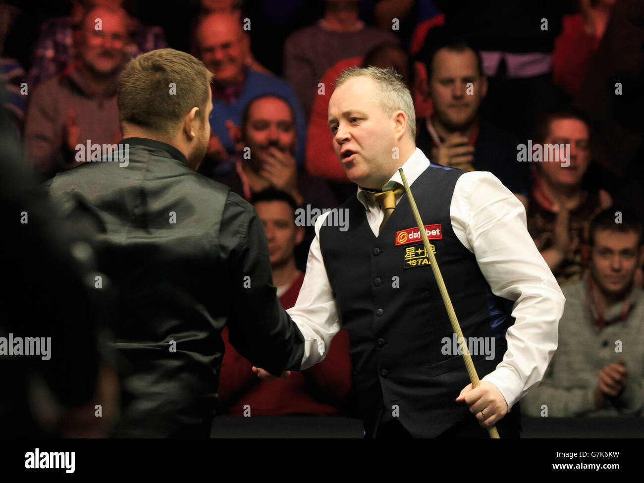 John Higgins, (right) shakes hands with Mark Allen, (left) after he is