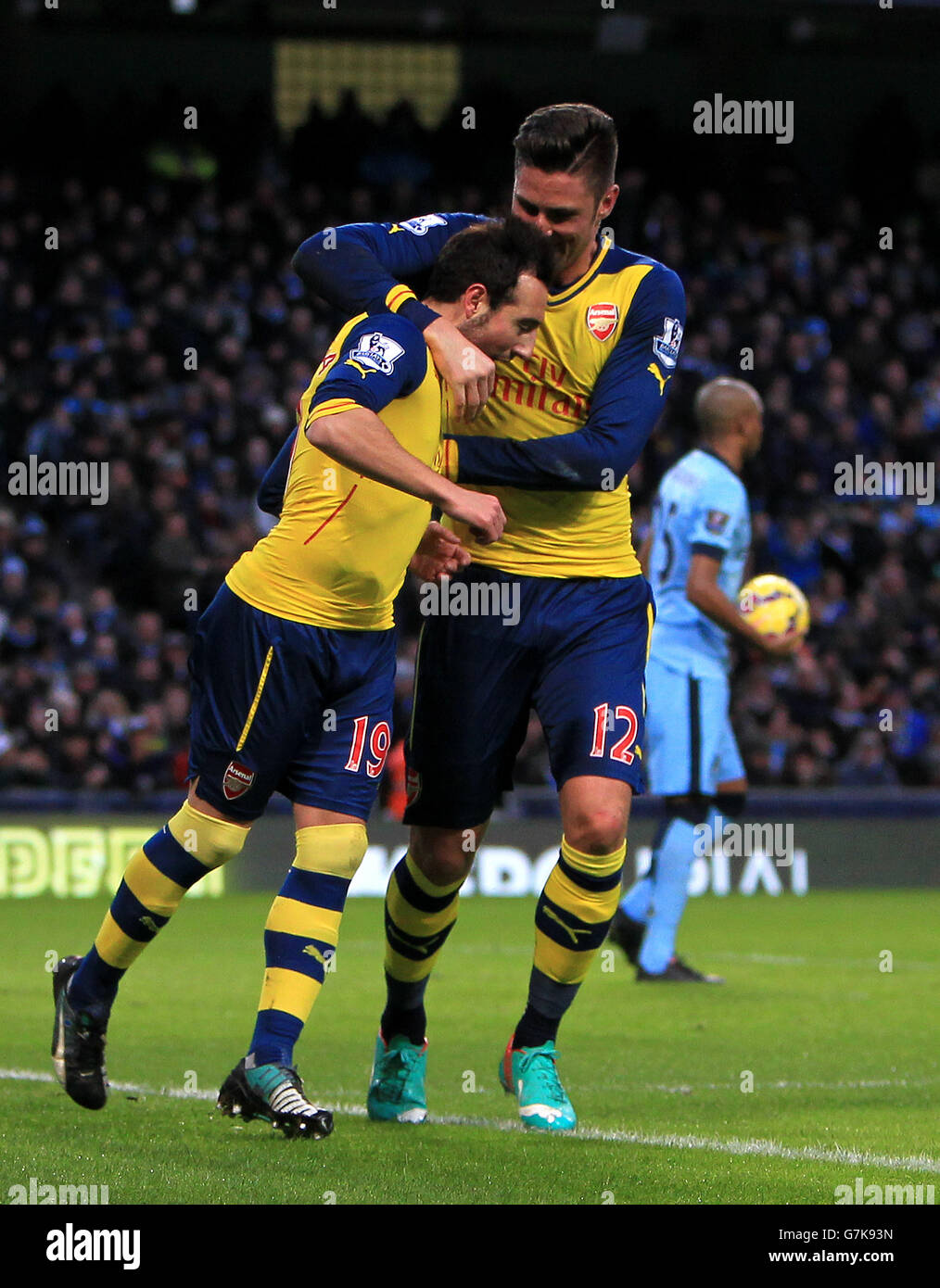 Arsenal's Santi Cazorla (left) celebrates scoring his sides first goal of the game during the Barclays Premier League match at the Etihad Stadium, Manchester. Stock Photo