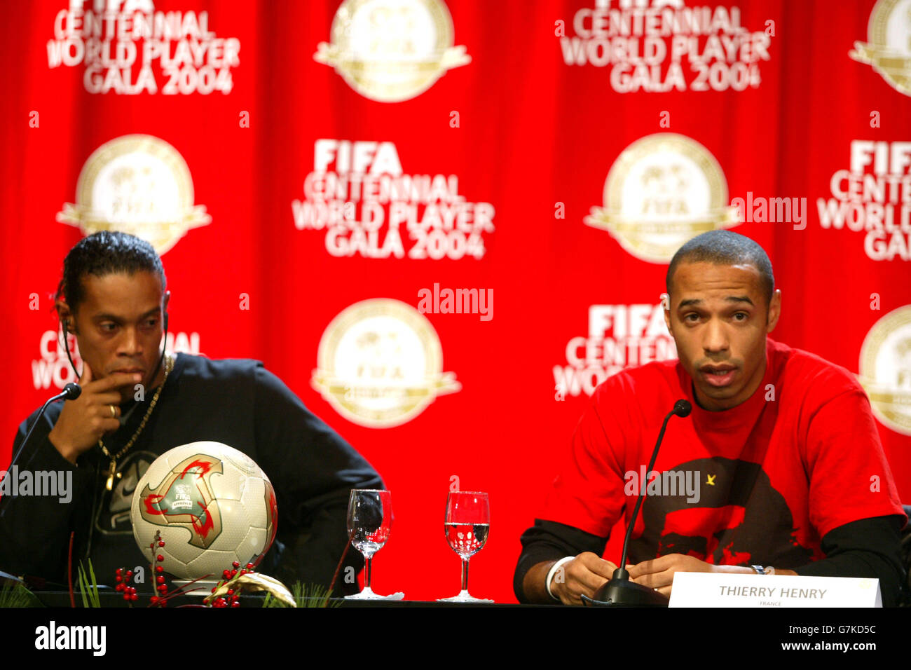 Soccer - FIFA World Player Gala 2004. France and Arsenal's Thierry Henry answers questions at the press conference as Brazil and Barcelona's Ronaldinho looks on Stock Photo
