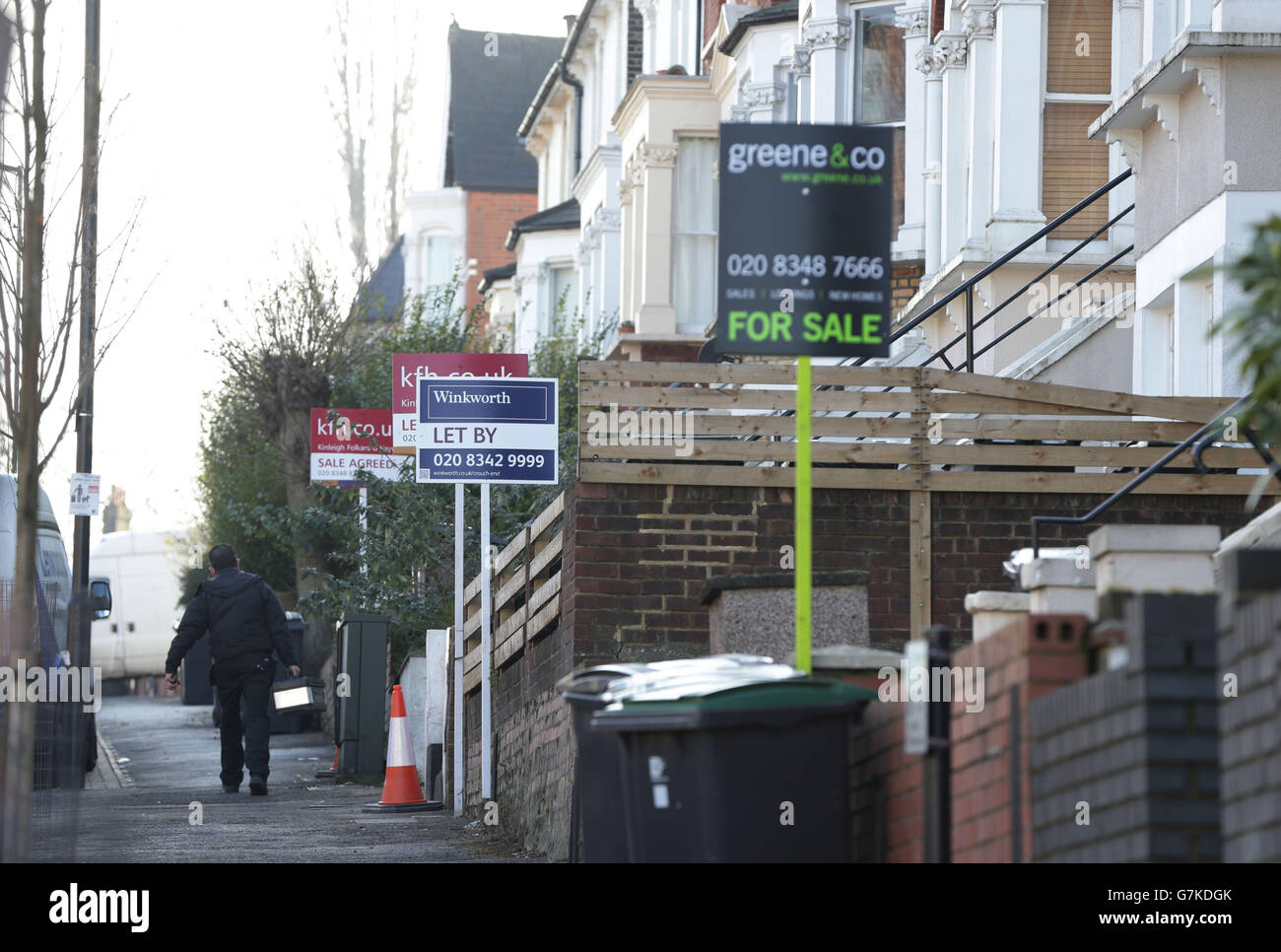 For Sale, Let By and Sale Agreed signs outside houses in north London