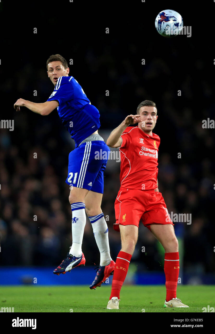Chelsea's Nemanja Matic (left) and Liverpool's Jordan Henderson battle for the ball in the air during the Capital One Cup Semi Final, Second Leg match at Stamford Bridge, London. PRESS ASSOCIATION Photo. Picture date: Tuesday January 27, 2015. See PA story: SOCCER Chelsea. Photo credit should read: Nick Potts/PA Wire. RESTRICTIONS: Maximum 45 images during a match. No video emulation or promotion as 'live'. No use in games, competitions, merchandise, betting or single club/player services. No use with unofficial audio, video, data, fixtures or club/league Stock Photo