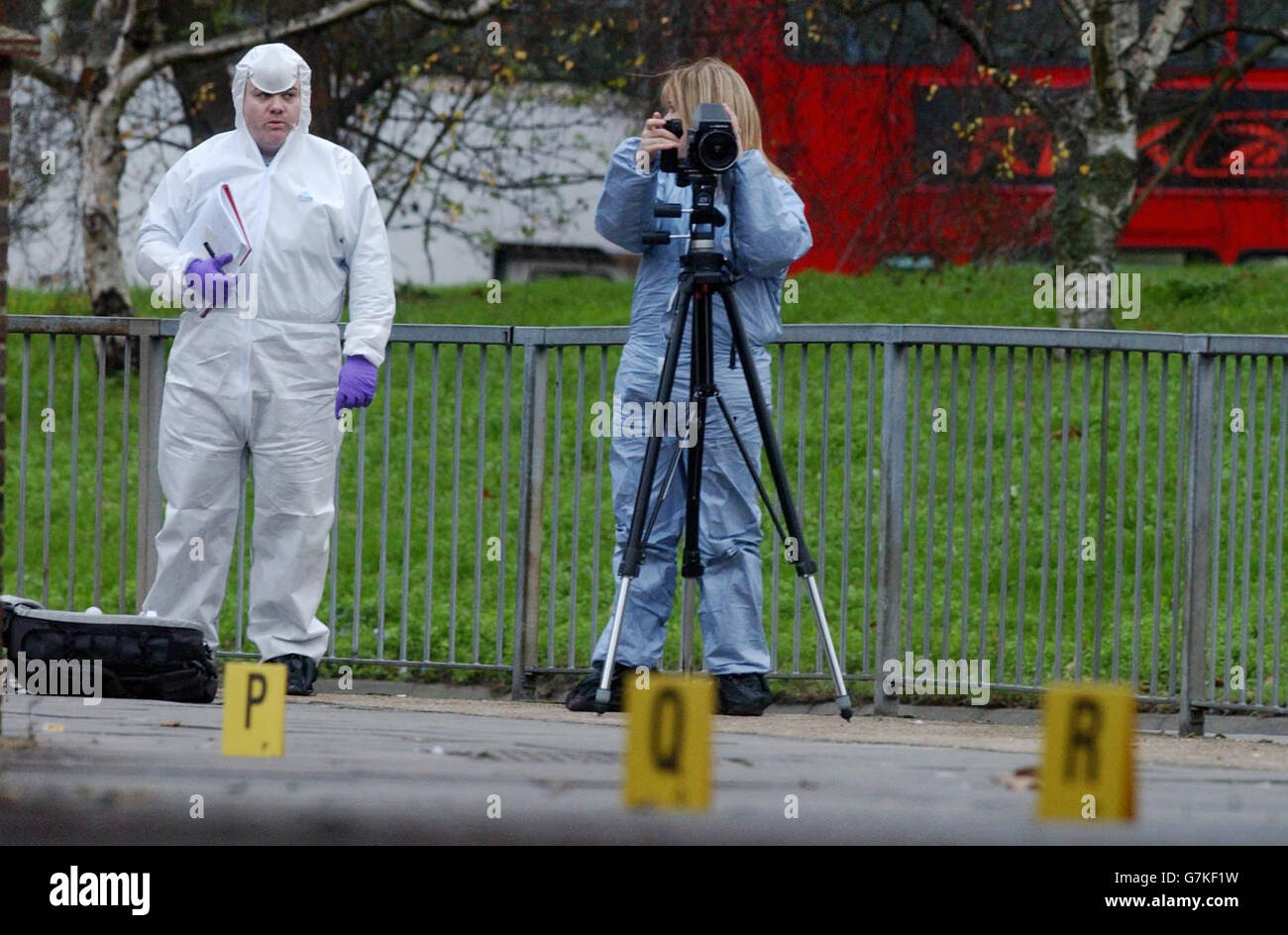 A Police forensics team record evidence at the scene of a stabbing