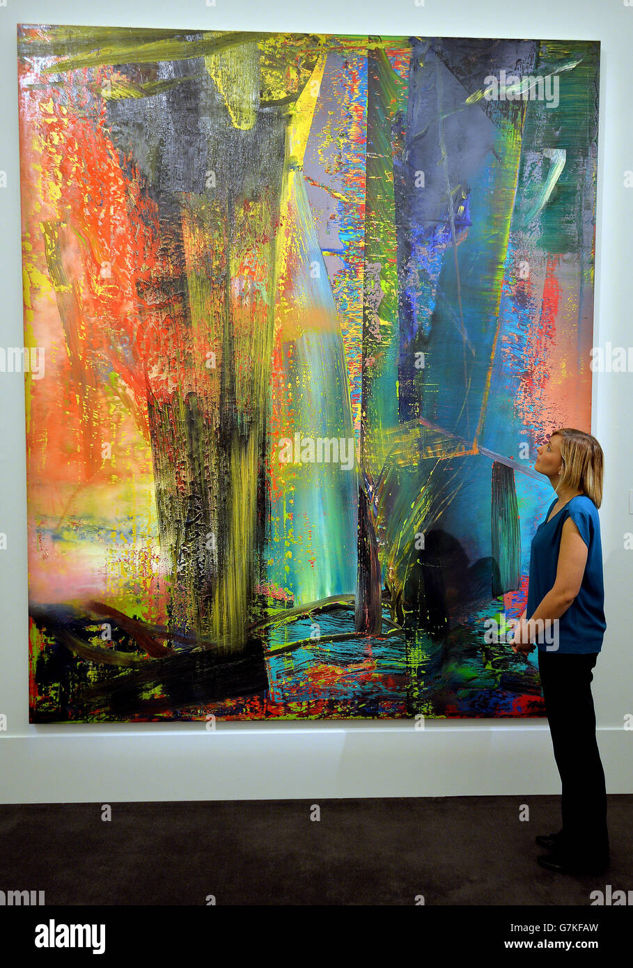 A young woman studies the Gerhard Richter painting Abstraktes Bild, which is estimated to be sold for between £14-20 million during the Impressionist and Modern auction at Sotheby's on 3rd February, on display at their showrooms in central London. Stock Photo
