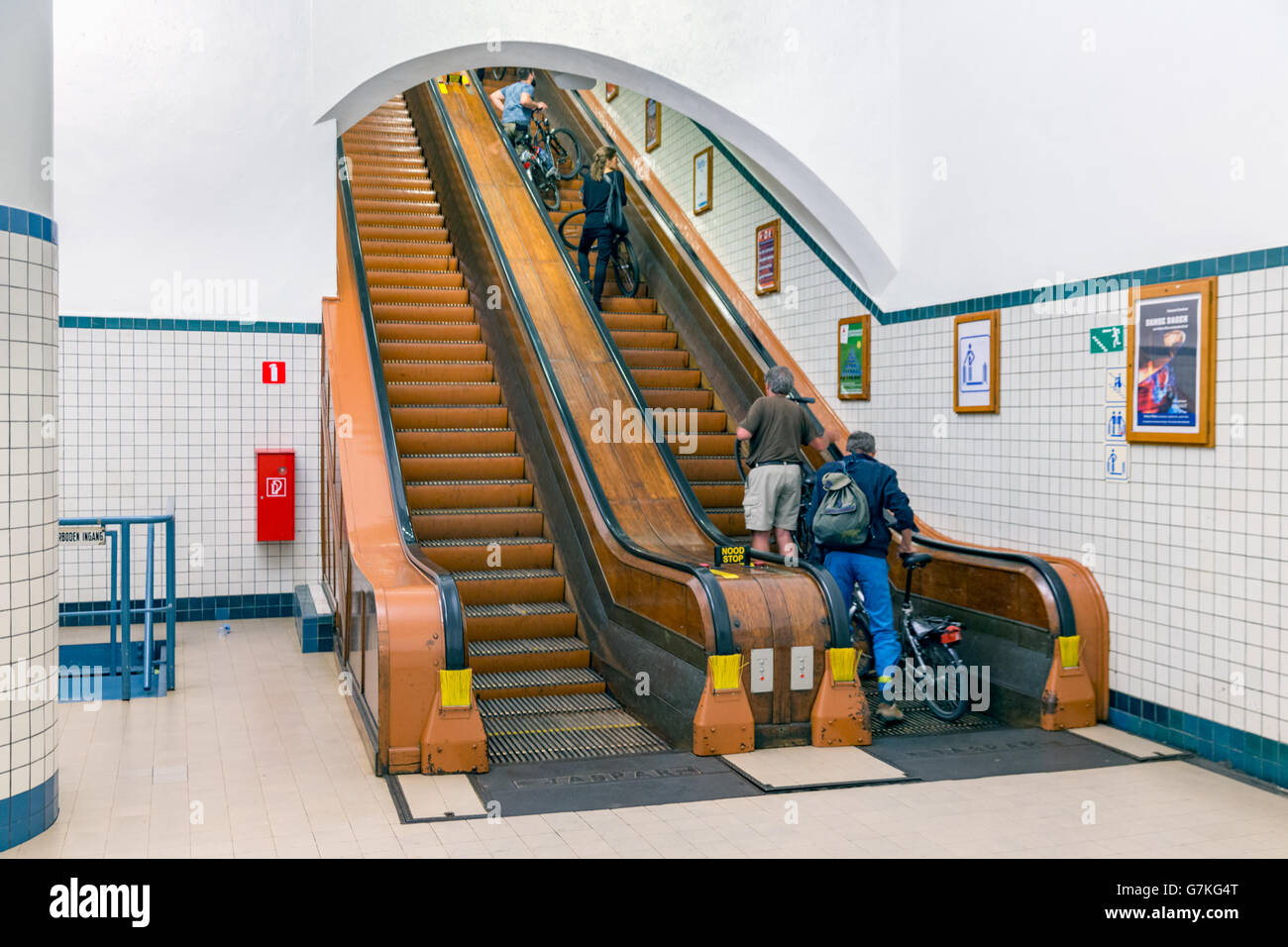 Pedestrians at a wooden escalator of the hiking tunnel under river