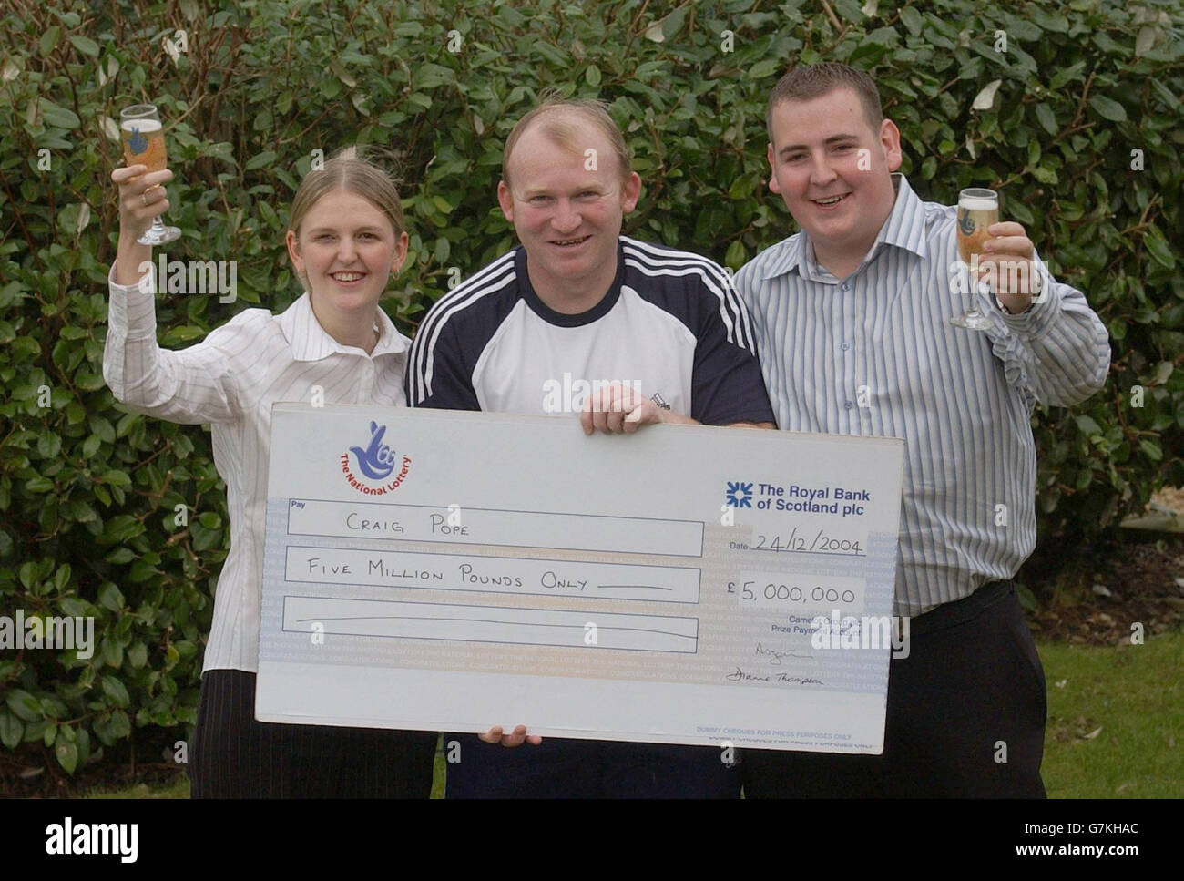 5 million National Lottery cheque from former Wales Rugby star Neil Jenkins (centre) in South ...