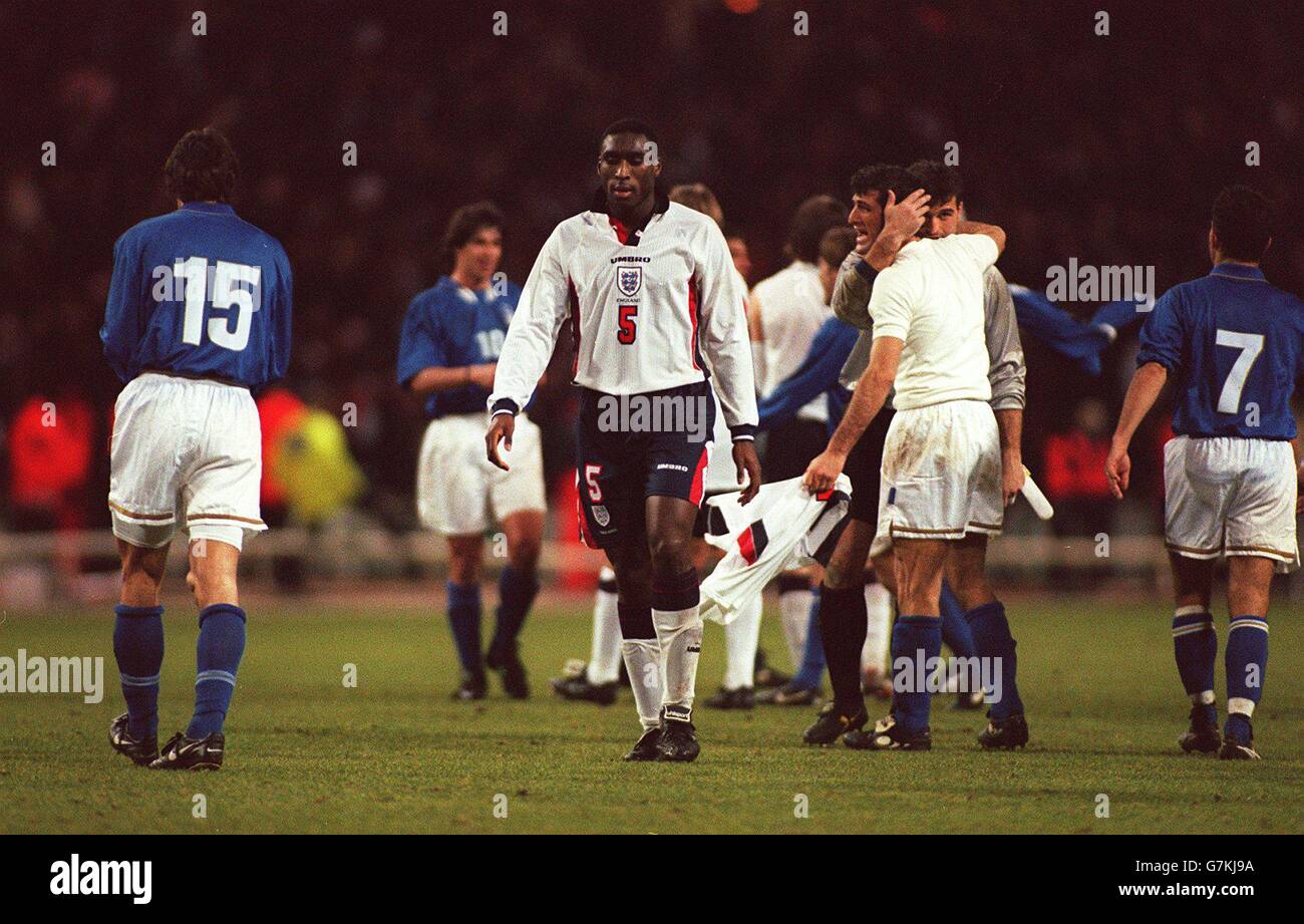 International Soccer - World Cup Qualifier - England v Italy. Sol Campbell, England walks from the field whilst Italy celebrate Stock Photo