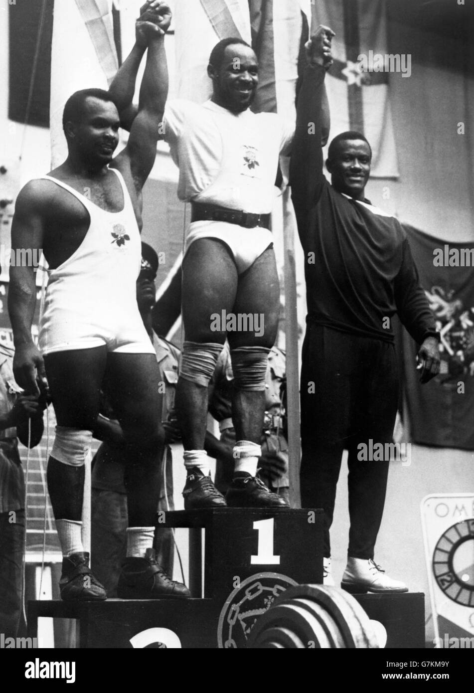England's Louis Martin claims the gold medal in the mid- heavyweight division of weightlifting. He is flanked by England's G Manners (left) and Jamaica's D Lawson. Stock Photo