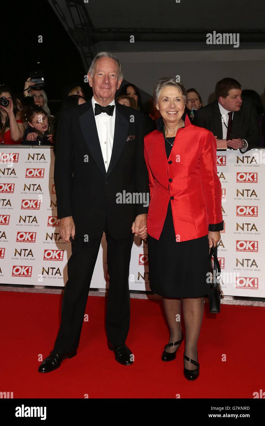 Michael Buerk and wife arriving for the 2015 National Television Awards at the O2 Arena, London. Stock Photo