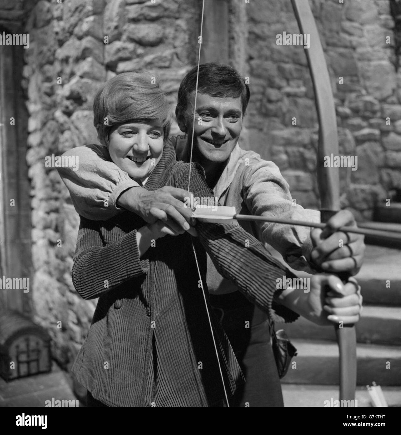Hood, alias actor Barrie Ingham, shows pop star, Cilla Black, how to use a bow and arrow. Barrie plays the legendary outlaw of Sherwood Forest in "A Challenge for Robin Hood",