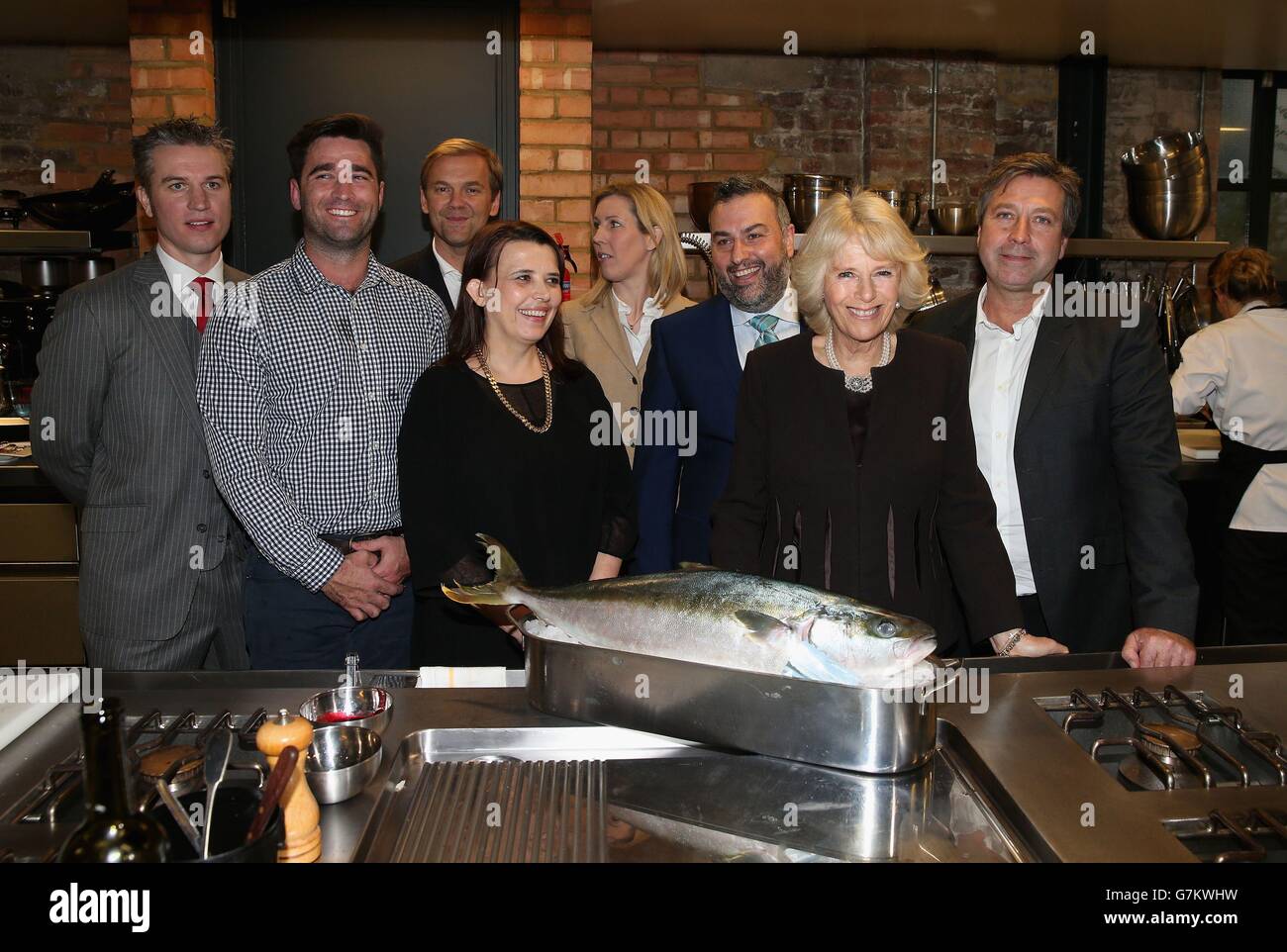 The Duchess of Cornwall poses for a photograph with Australian chef Lynton Tapp (second left) and Rachel O'Sullivan, John Torode, Bill Granger, Luke Rayment, Christian Honor and Clare Smyth during a cooking demonstration at an Australian Day Reception at The Violin Factory in London. As well as Australian cooking the Duchess sampled some Australian wines and met the producers. Stock Photo