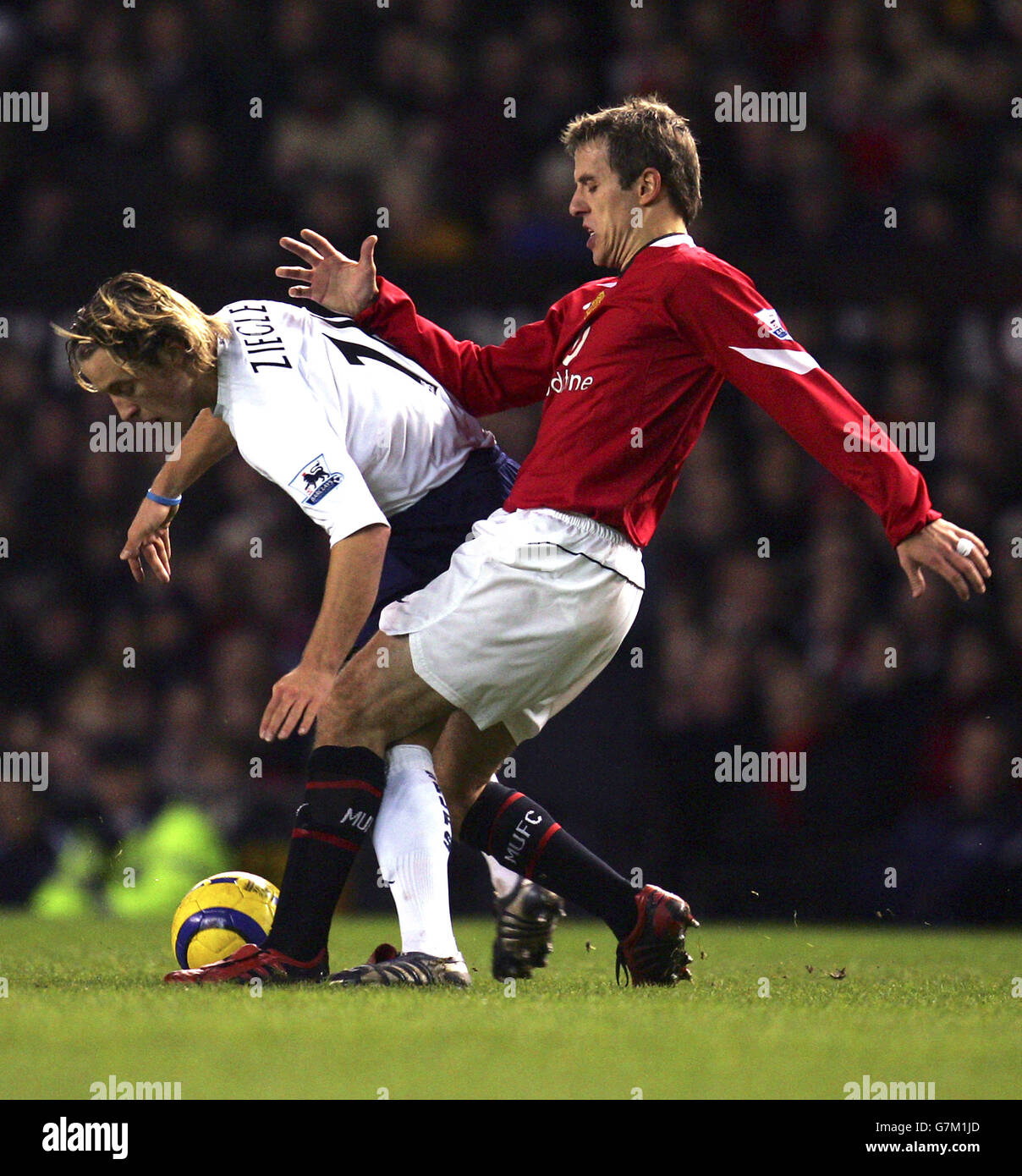 Soccer - FA Barclays Premiership - Manchester United v Tottenham Hotspur. Manchester United's Phil Neville and Tottenham Hotspur's Reto Ziegler Stock Photo