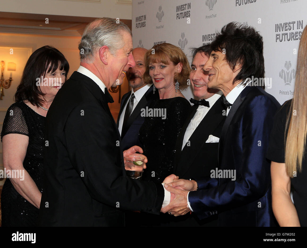The Prince of Wales meets (3rd left - right) Sir Ben Kingsley, Samantha Bond, Jools Holland and Ronnie Wood as he attends the annual Prince's Trust 'Invest In Futures' reception at the Savoy Hotel in London. Stock Photo