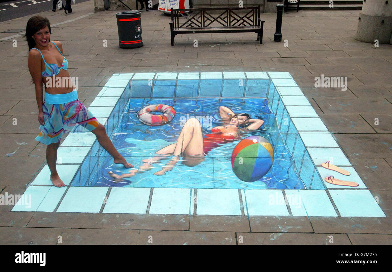 Miss England Danielle Llloyd dips her feet in the water with a 3D illusion of a swimming pool by pavement artist Julian Beever. Stock Photo