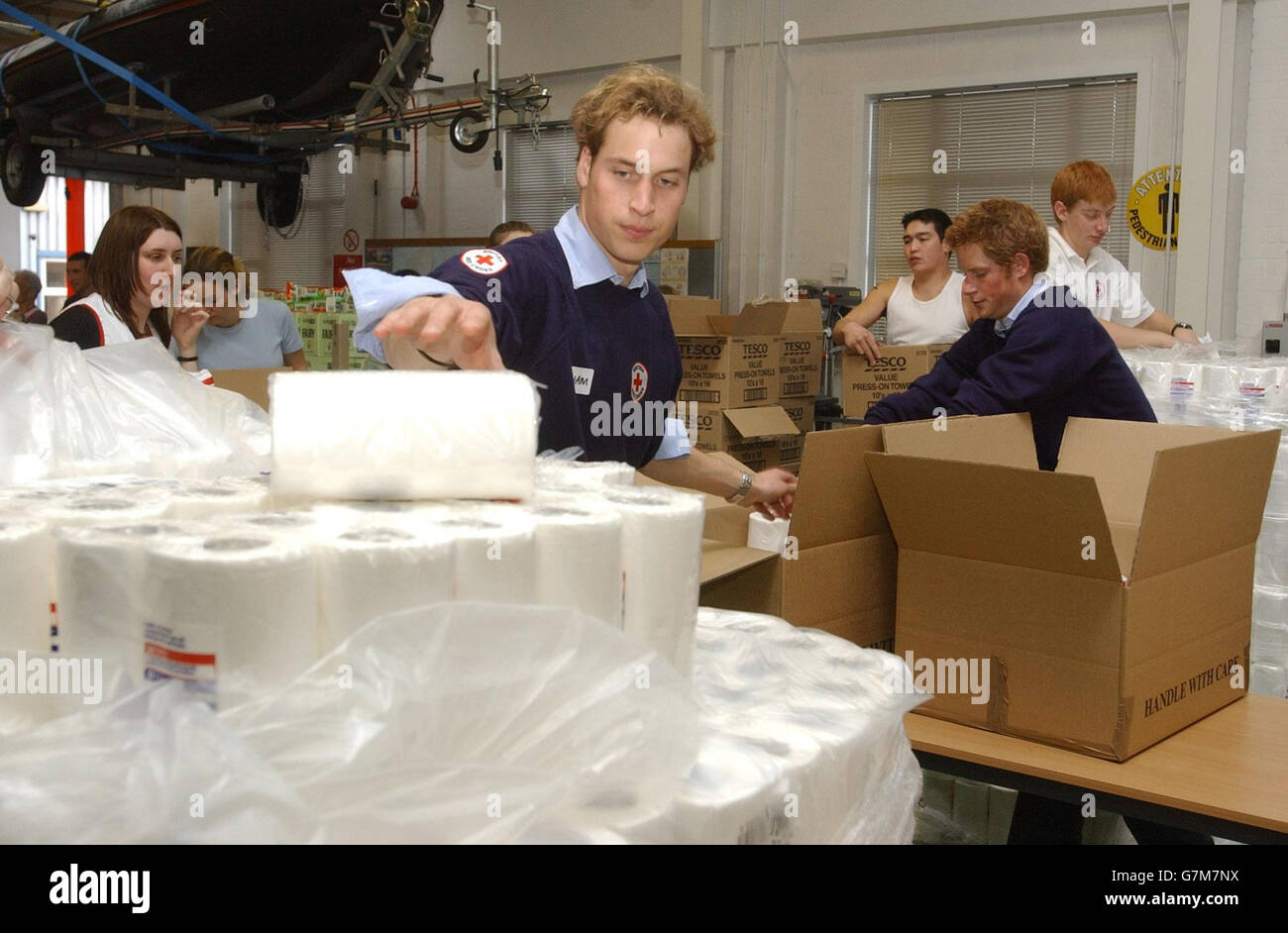 Prince William (left) and Prince Harry help with the packing of items bound for the Maldives. WPA Rota Stock Photo