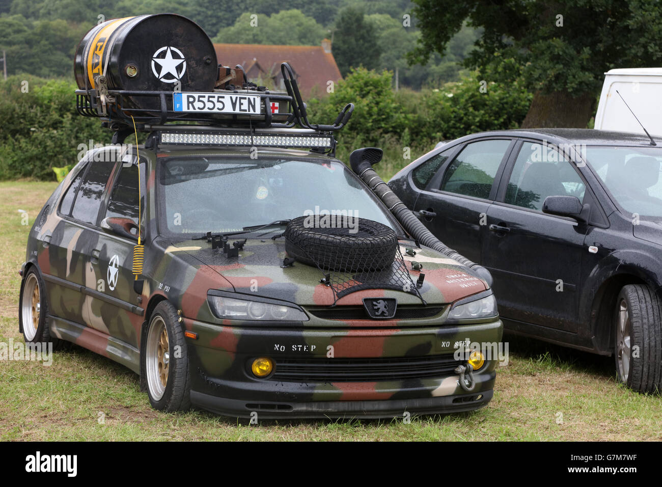 June 2016 - Old Peugeot 306 car done up in military gear at  the SWTPA event at Greendale Farm, Draycott, Somerset, near Cheddar. Stock Photo