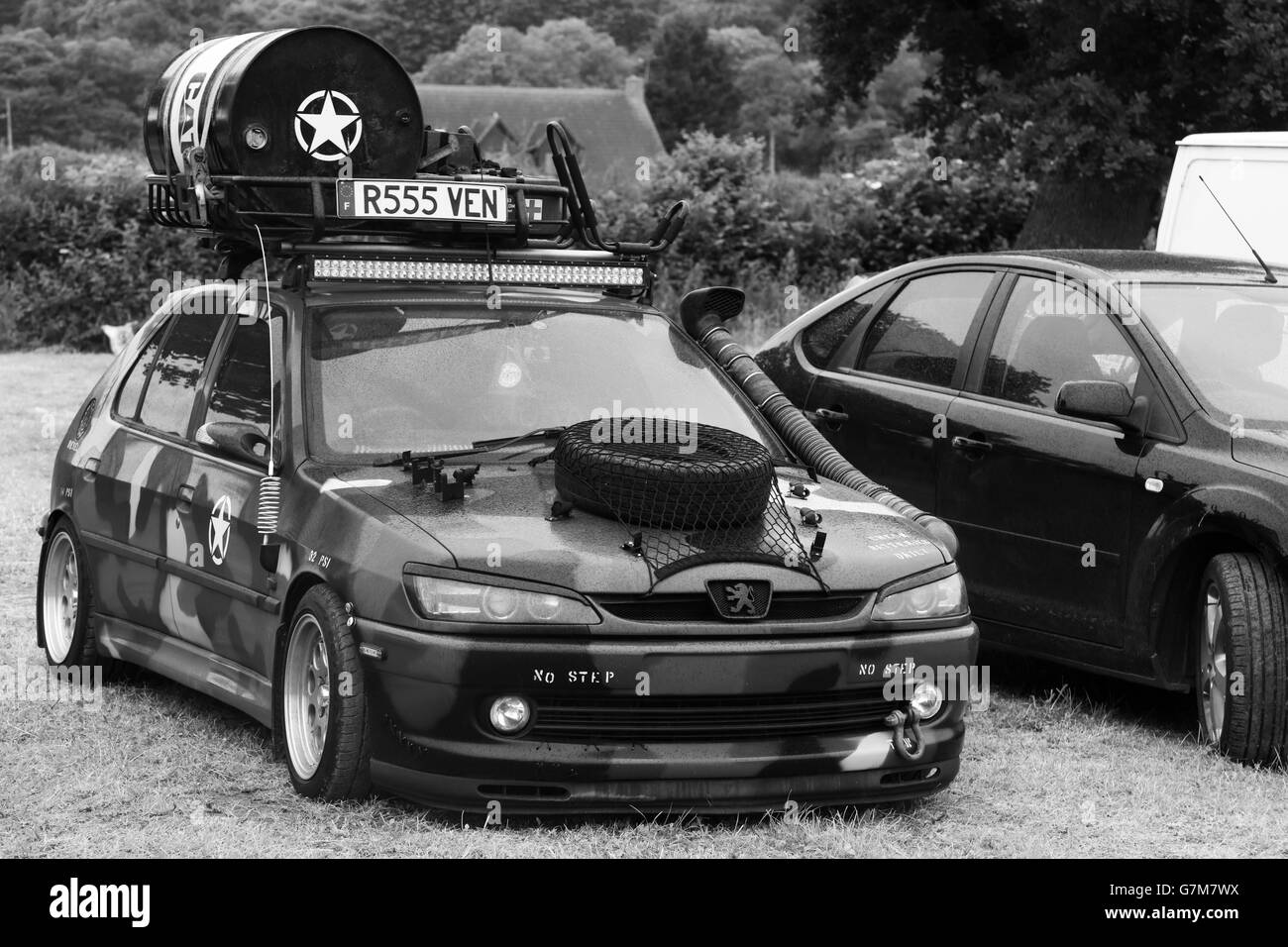 June 2016 - Old Peugeot 306 car done up in military gear at  the SWTPA event at Greendale Farm, Draycott, Somerset, near Cheddar. Stock Photo