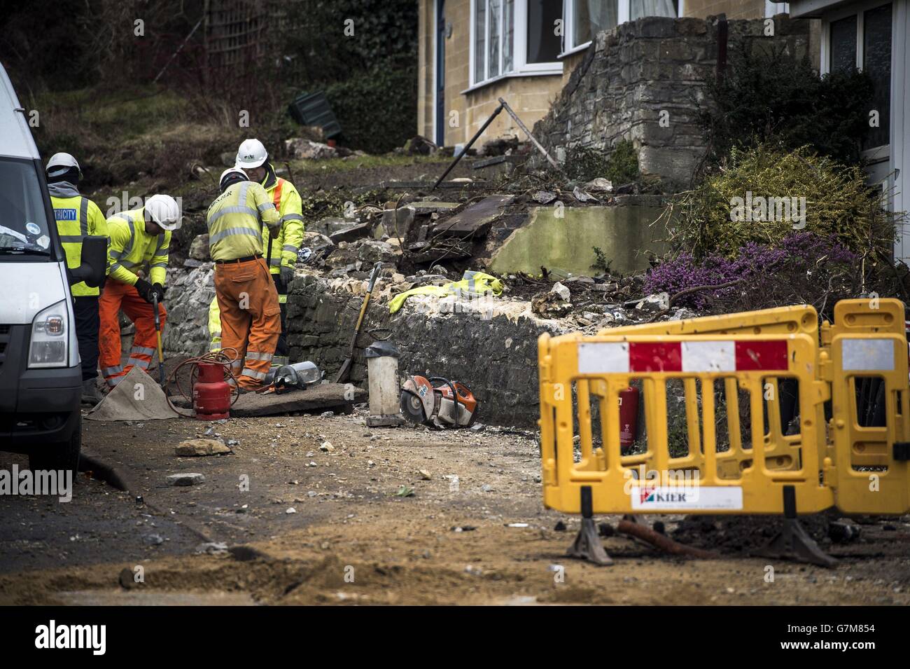 Workers remove debris at the crash site on Lansdown Lane, Bath, where