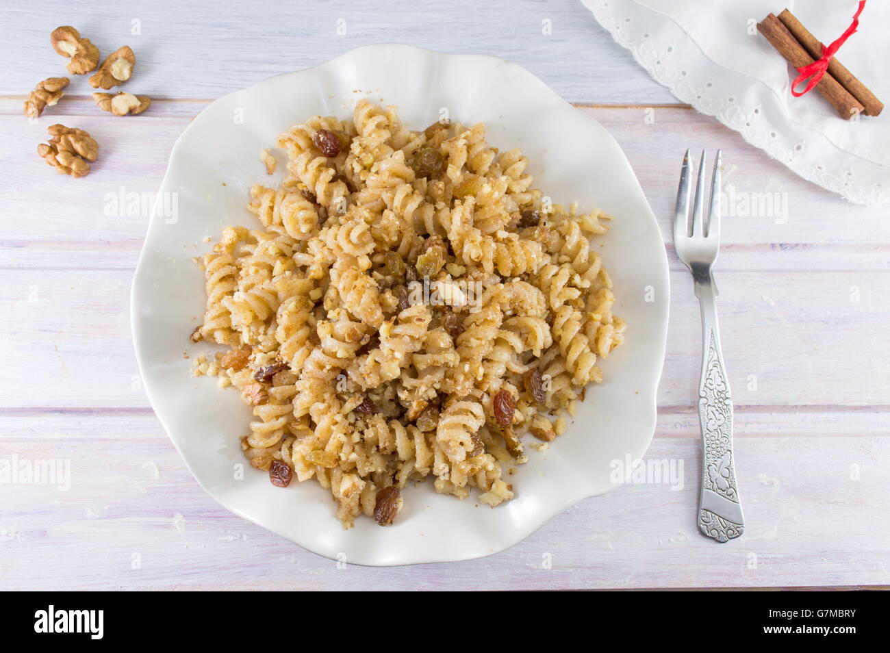 Sweet pasta with honey, nuts raisins and brown sugar Stock Photo