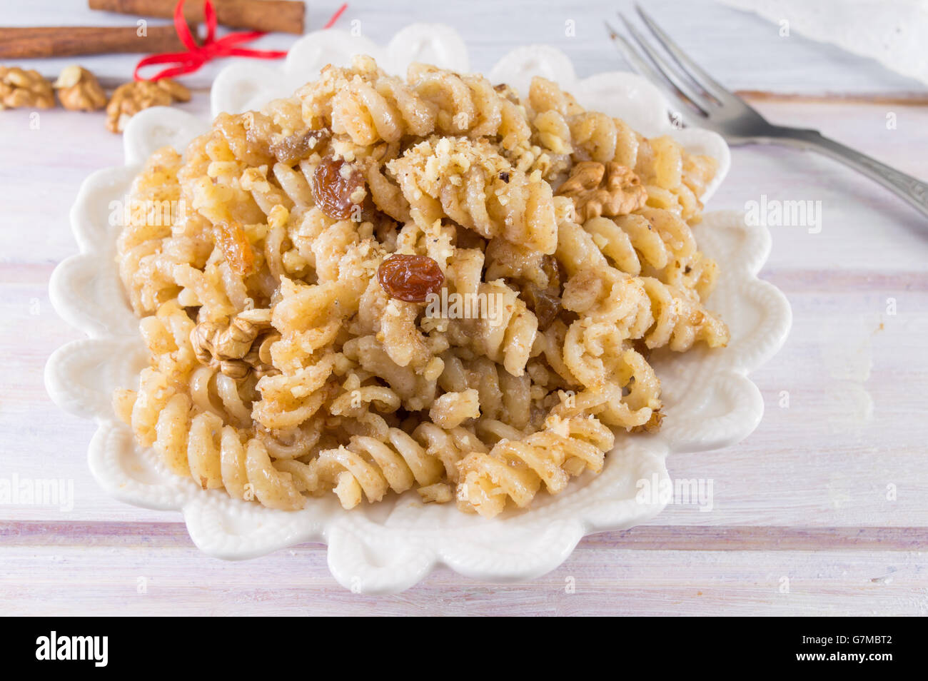 Sweet pasta with honey, nuts raisins and brown sugar Stock Photo