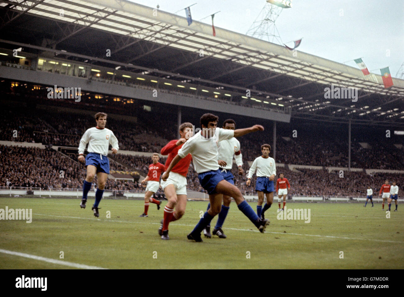 Portugal's Alberto Festa (third r) hacks the ball clear, watched by teammates Jose Carlos (l), Mario Coluna (second r) and Alexandre Baptista (r), and USSR's Anatoly Banishevski (second l) and Eduard Malofeev (third l) Stock Photo