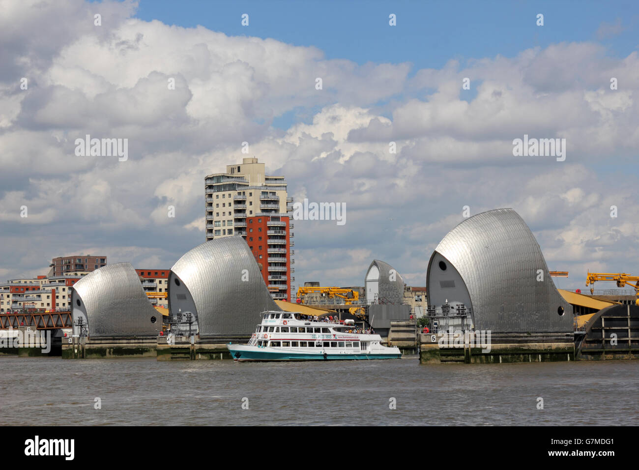 Boat passes through the Thames Barrier, London England UK Stock Photo