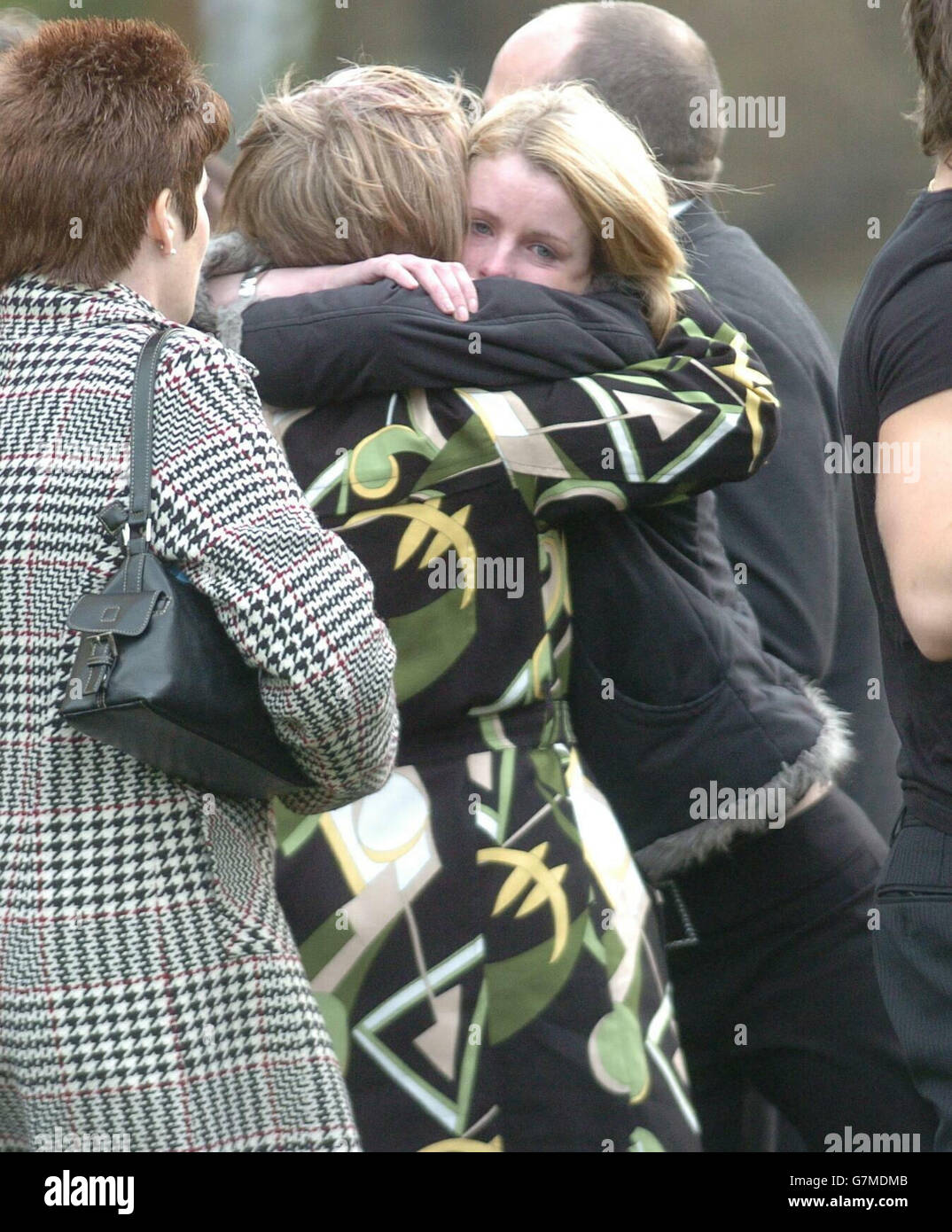 Friends family comfort each other after the funeral of sally hires