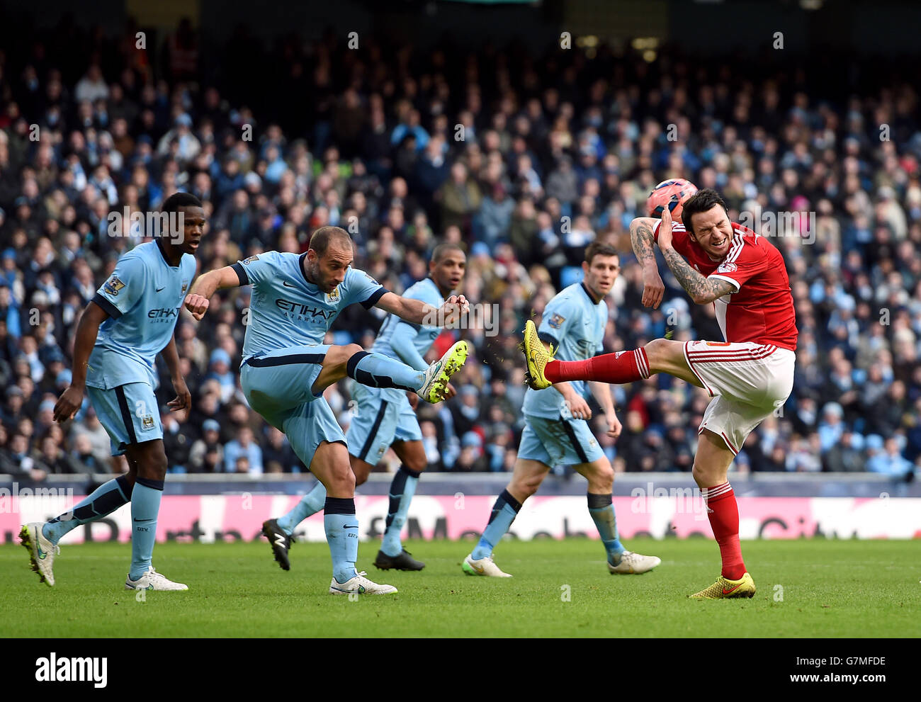 Manchester City's Pablo Zabaleta clears as Middlesbrough's Lee Tomlin ...