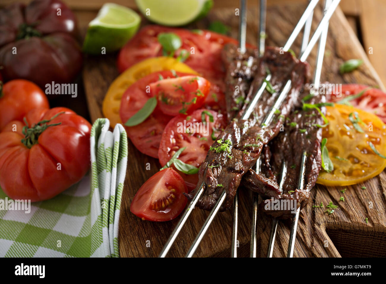 Flank steak on skewers with tomatoes Stock Photo Alamy