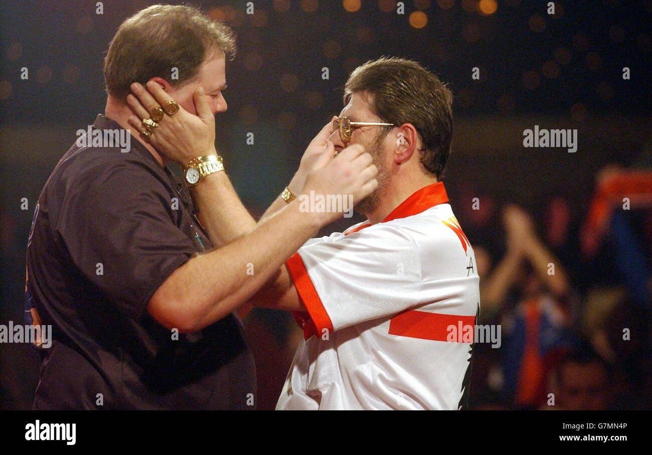 Lakeside World Championship Final. Raymond van Barneveld (left) consoles Martin Adams after winning. Stock Photo