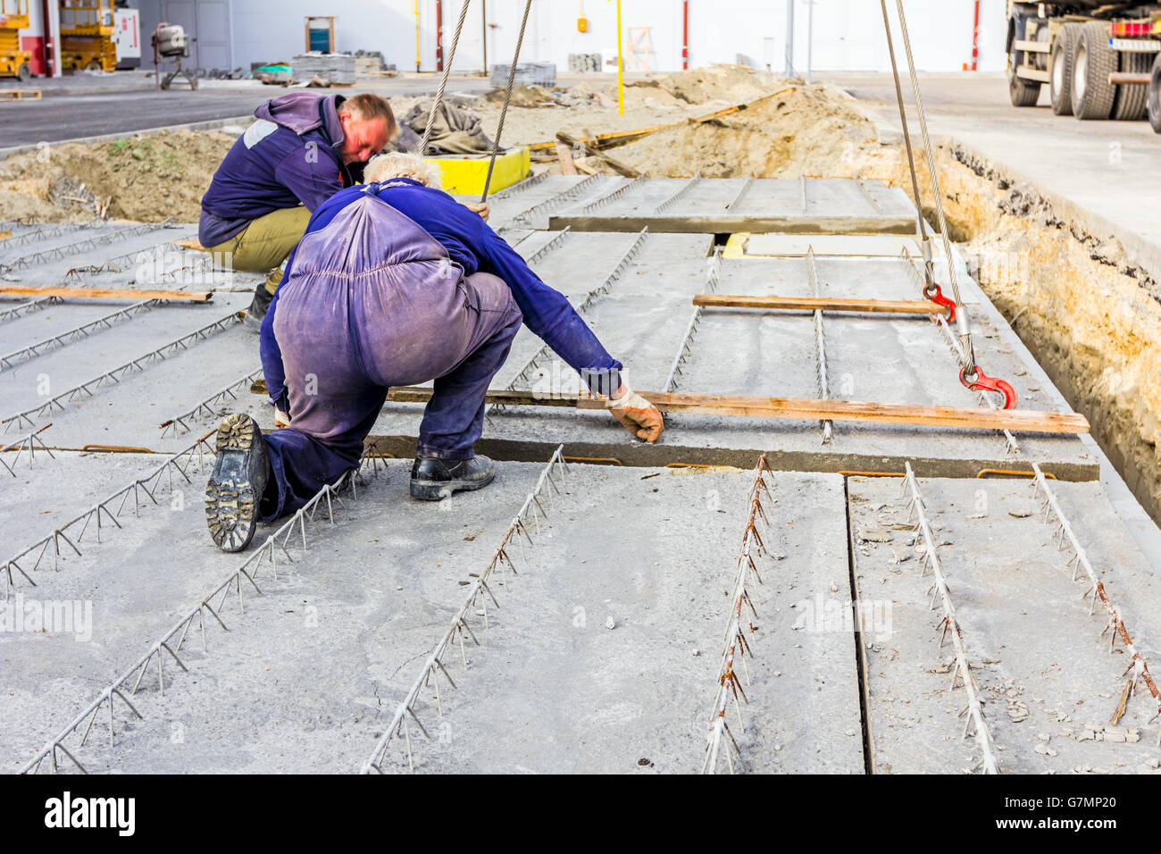 Workers are set up concrete slab to assembly underground edifice Stock ...