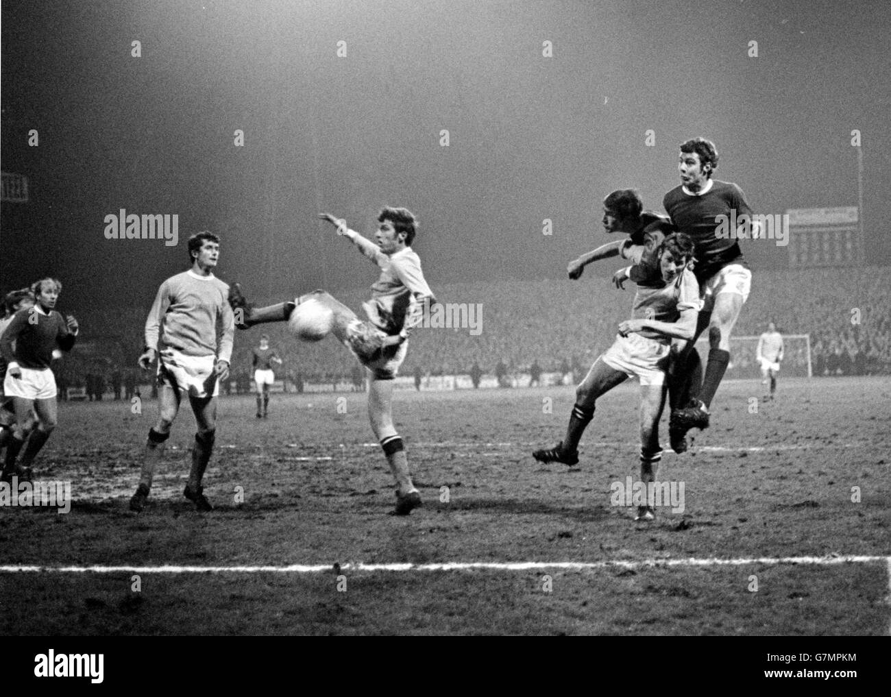 Manchester City's Tommy Booth (third l) blocks a header from Manchester United's Brian Kidd (r), watched by City's Mike Doyle (second l) and Tony Book (second r), and United's Paul Edwards (third r) and Bobby Charlton (l) Stock Photo