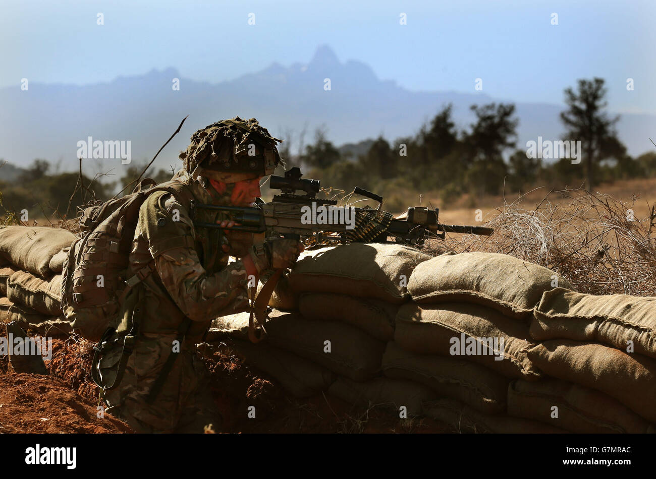 A soldier from the 2nd Battalion, The Royal Regiment of Scotland takes aim in front of Mount Kenya as he takes part in Exercise Askari Storm on the outskirts of Nanyuki, Kenya. Stock Photo