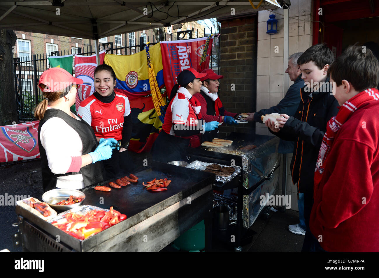 Arsenal fans get a snack from a food stall prior to the game Stock Photo - Alamy