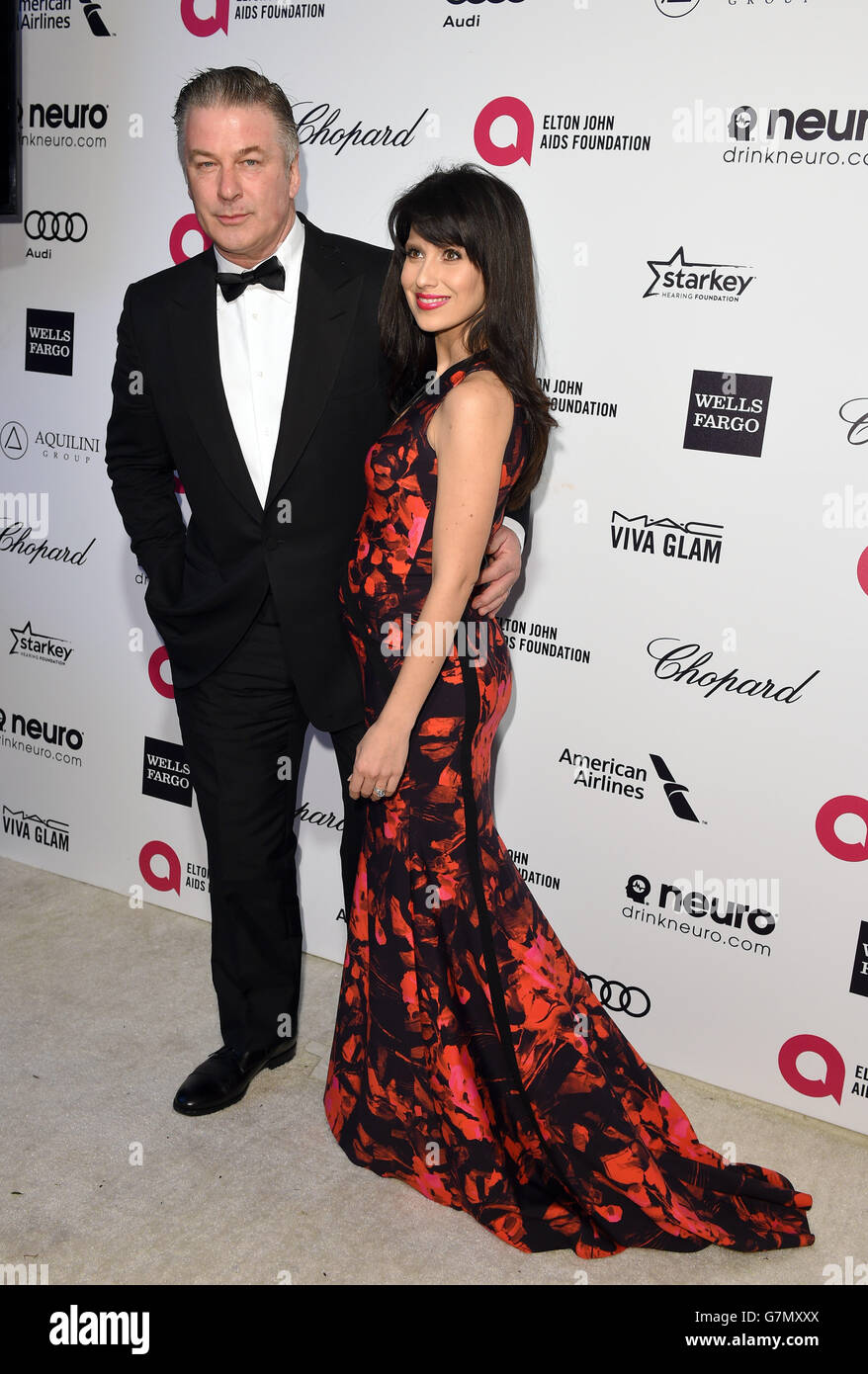 Alec Baldwin and Hilaria Baldwin arrive for the Elton John AIDS Foundation's 23rd annual Academy Awards Viewing Party at West Hollywood Park in Los Angeles. Stock Photo