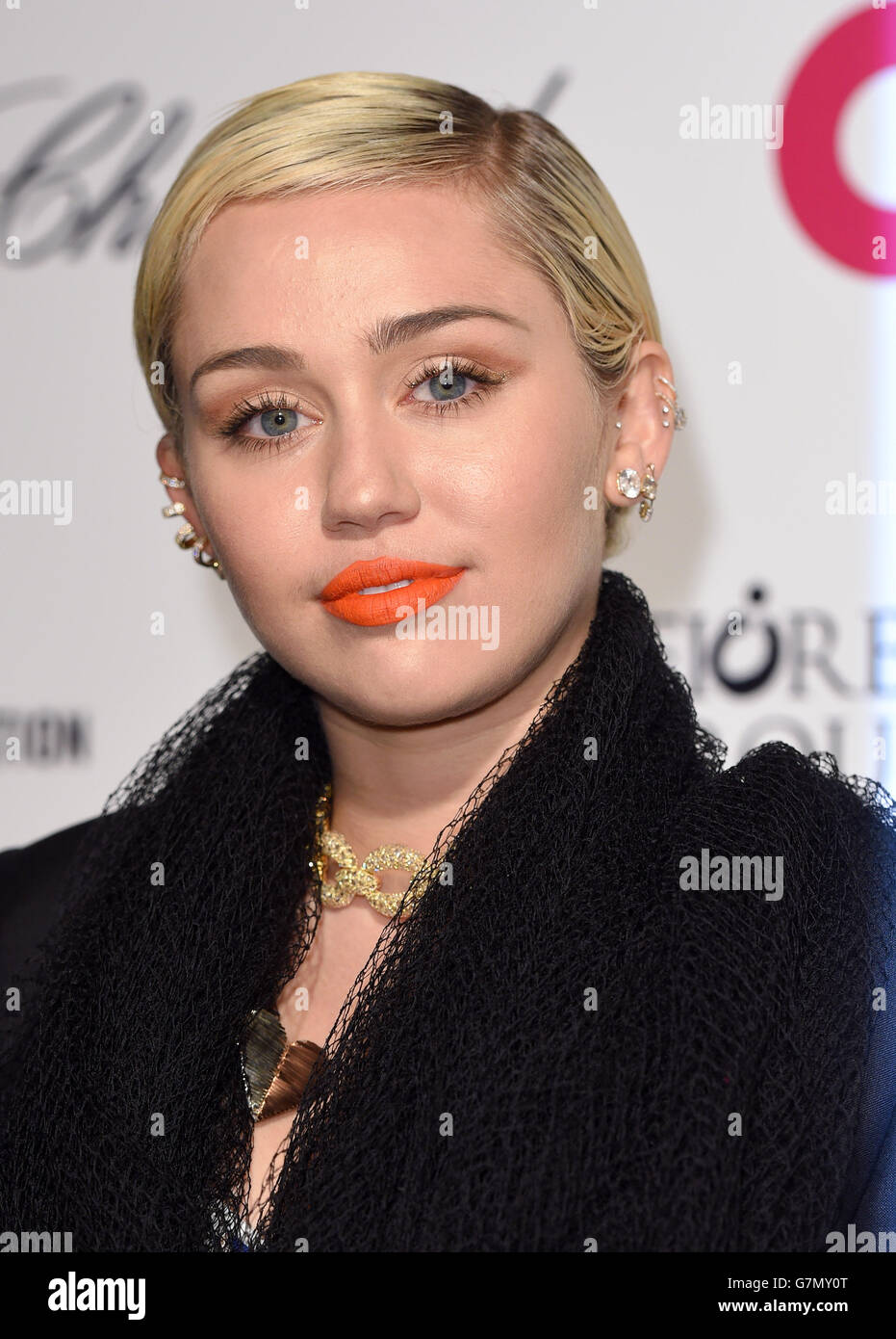 Miley Cyrus arrives for the Elton John AIDS Foundation's 23rd annual Academy Awards Viewing Party at West Hollywood Park in Los Angeles. Stock Photo